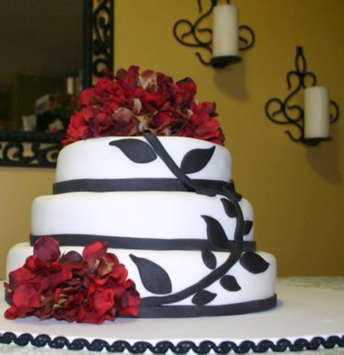 Red flowers black vines white fondant wedding cake